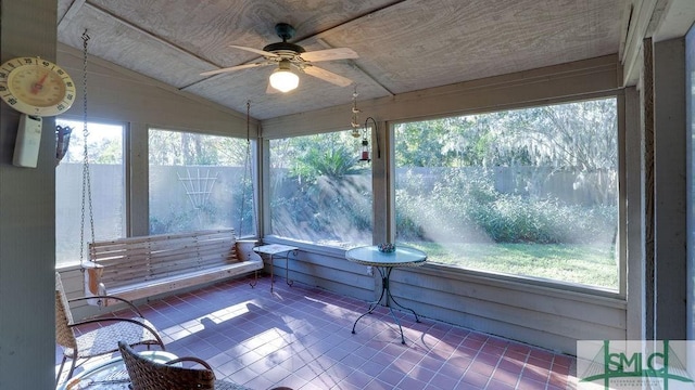 sunroom with ceiling fan and lofted ceiling