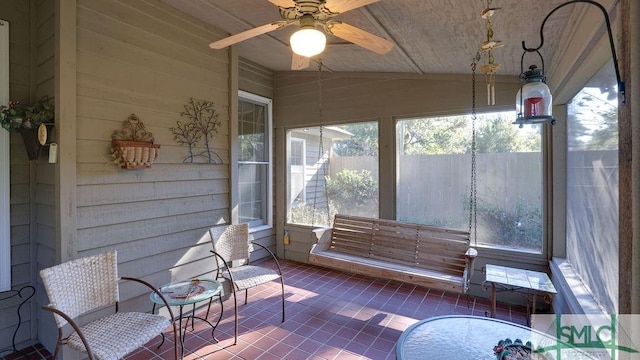 sunroom / solarium featuring ceiling fan and vaulted ceiling