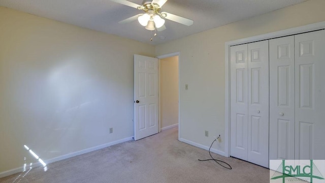 unfurnished bedroom with light carpet, a closet, and ceiling fan