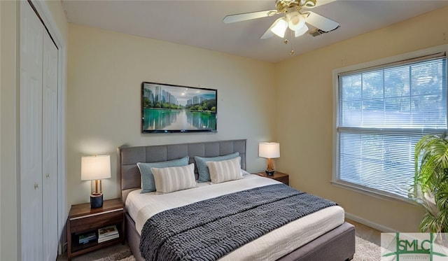 bedroom featuring ceiling fan, wood-type flooring, and a closet