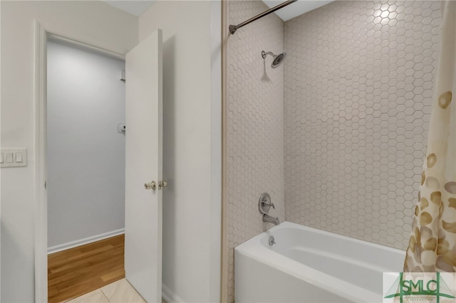 bathroom featuring shower / bath combination with curtain and hardwood / wood-style flooring