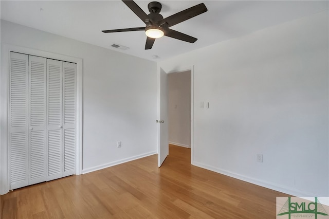 unfurnished bedroom featuring ceiling fan, a closet, and light hardwood / wood-style floors