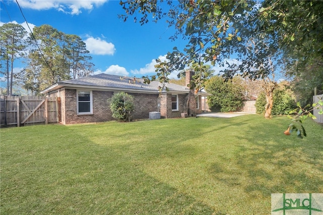 view of yard with a patio and central AC unit