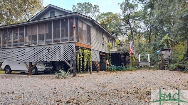 view of home's exterior with a sunroom