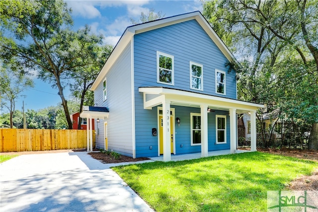 view of front facade featuring covered porch and a front yard