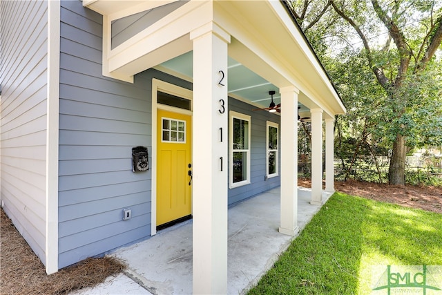 view of exterior entry with ceiling fan