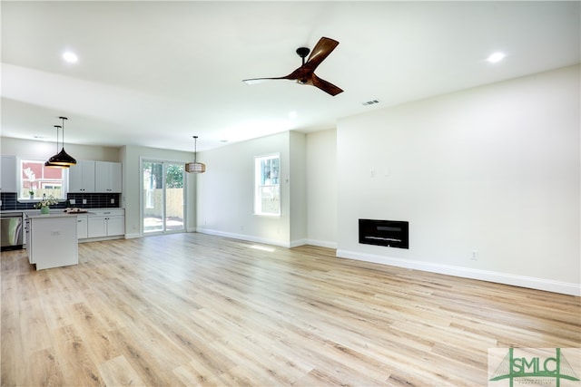 unfurnished living room with ceiling fan and light wood-type flooring