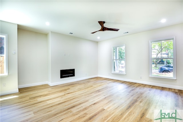 unfurnished living room with ceiling fan and light hardwood / wood-style flooring