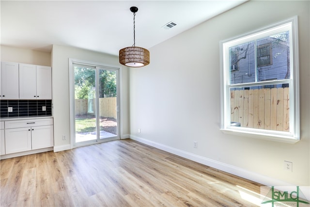 unfurnished dining area with light hardwood / wood-style flooring