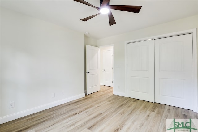 unfurnished bedroom with ceiling fan, light hardwood / wood-style floors, and a closet