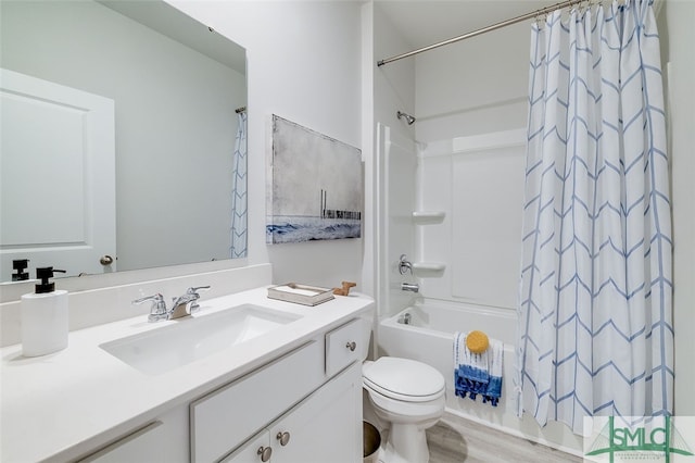 full bathroom with hardwood / wood-style floors, vanity, shower / tub combo, and toilet