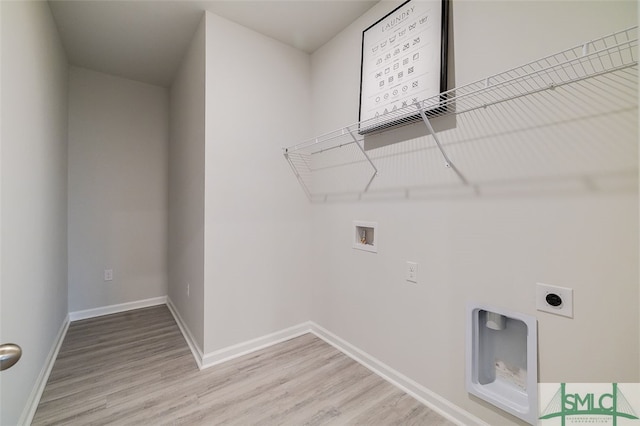 laundry area with washer hookup, light hardwood / wood-style floors, and hookup for an electric dryer