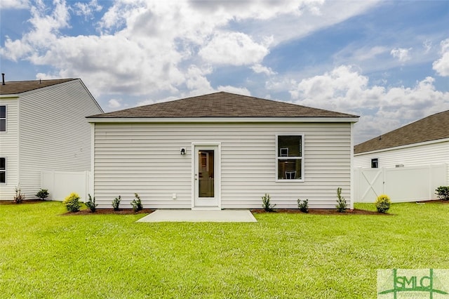 back of property featuring a yard and a patio