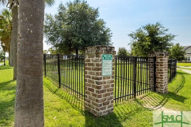 view of gate featuring a lawn