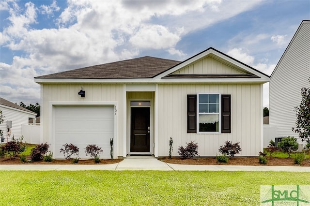 view of front of home with a front lawn and a garage