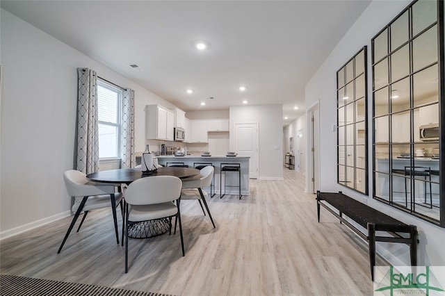 dining space with light wood-type flooring