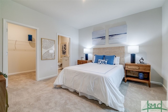 bedroom featuring carpet, connected bathroom, a spacious closet, and a closet