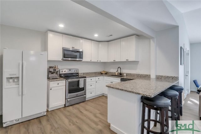 17 S Lake Dr, Savannah, GA 31410 - kitchen with appliances with stainless steel finishes, a sink, white cabinets, and recessed lighting