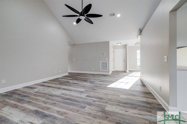 unfurnished living room with hardwood / wood-style floors, high vaulted ceiling, and ceiling fan