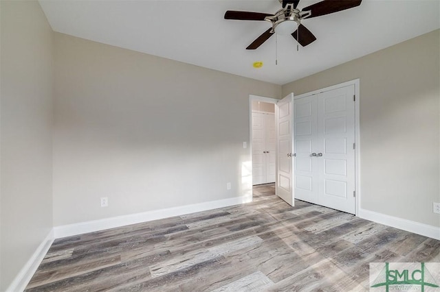 unfurnished bedroom with a closet, light hardwood / wood-style flooring, and ceiling fan