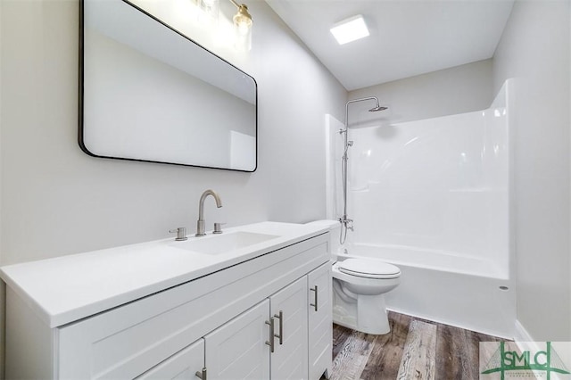 full bathroom featuring bathing tub / shower combination, toilet, vanity, and hardwood / wood-style flooring