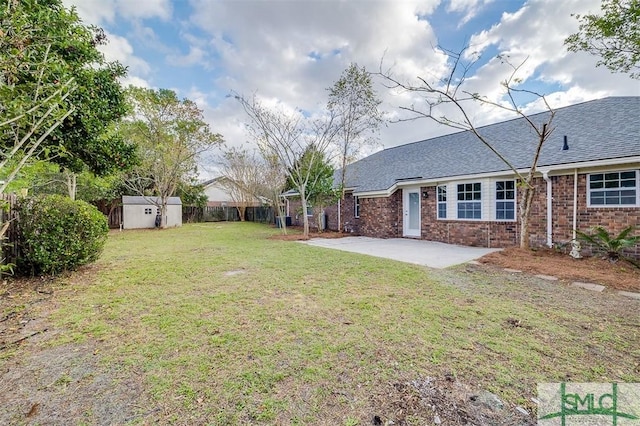 view of yard featuring a shed and a patio area