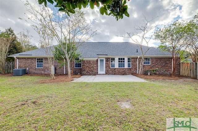 rear view of house featuring a lawn, central air condition unit, and a patio