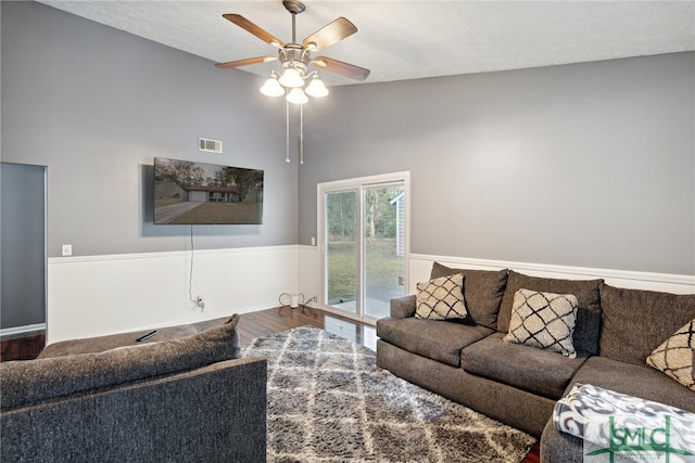 living room featuring wood-type flooring and ceiling fan