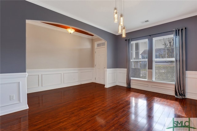 empty room with dark hardwood / wood-style flooring and ornamental molding