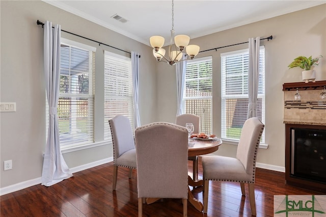 dining room with ornamental molding, dark wood-type flooring, and a notable chandelier