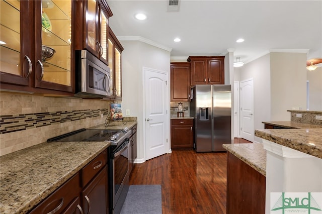 kitchen featuring dark wood-type flooring, crown molding, light stone countertops, appliances with stainless steel finishes, and tasteful backsplash