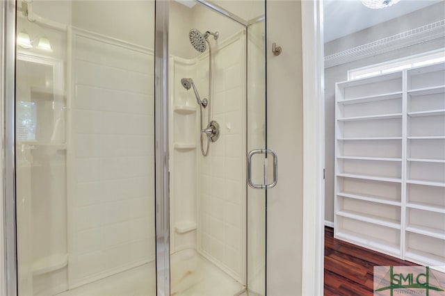 bathroom featuring wood-type flooring and walk in shower