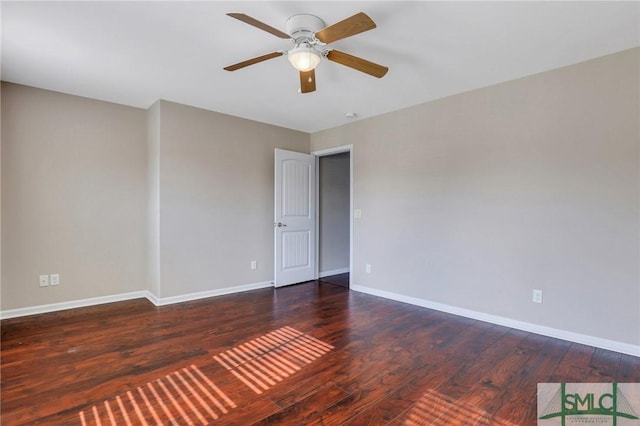 empty room featuring ceiling fan and dark hardwood / wood-style flooring