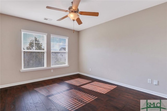 empty room featuring ceiling fan and dark wood-type flooring