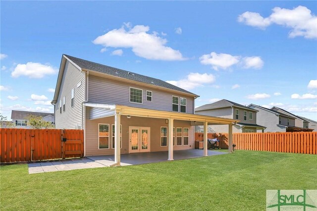 back of property with a lawn and a patio