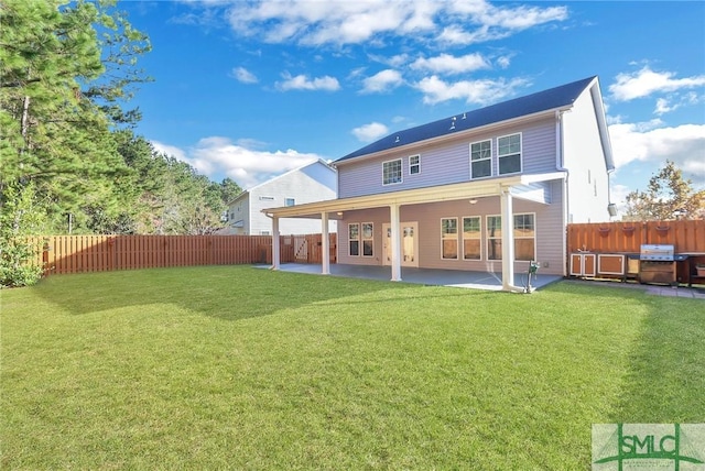 rear view of property featuring a patio and a lawn