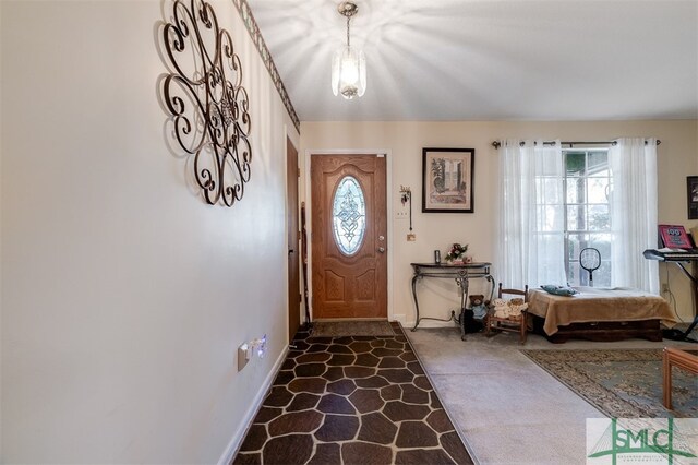 view of carpeted foyer entrance