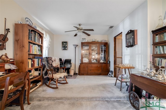 living area featuring ceiling fan and light carpet