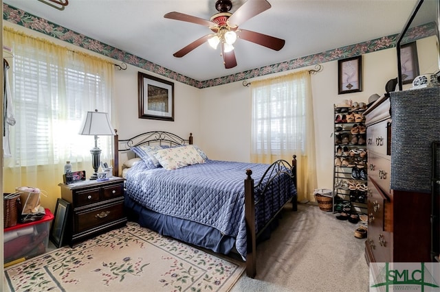 bedroom featuring light carpet and ceiling fan