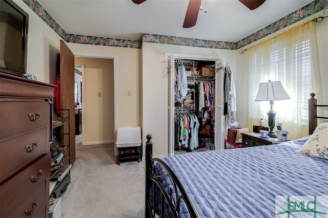 bedroom with ceiling fan, a closet, and light colored carpet