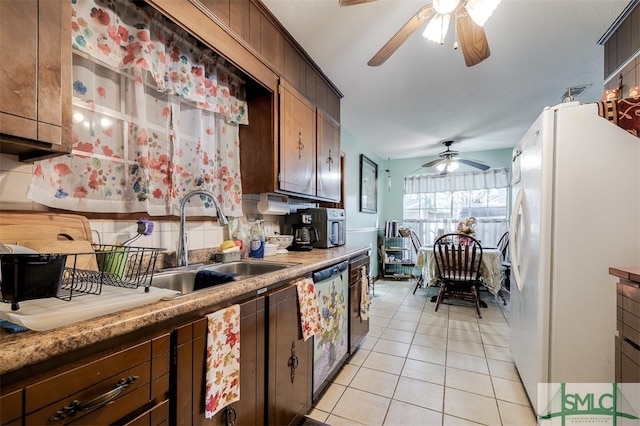 kitchen with stainless steel dishwasher, ceiling fan, sink, light tile patterned floors, and white fridge