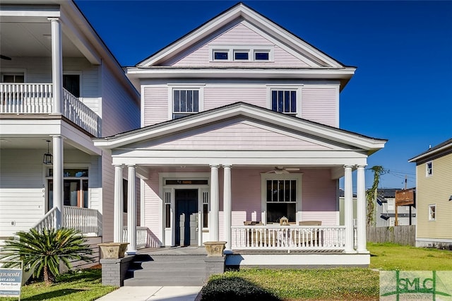 greek revival house featuring ceiling fan and a porch