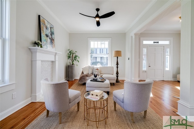 sitting room with light hardwood / wood-style floors and crown molding