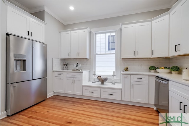 kitchen with tasteful backsplash, white cabinetry, stainless steel appliances, and light wood-type flooring