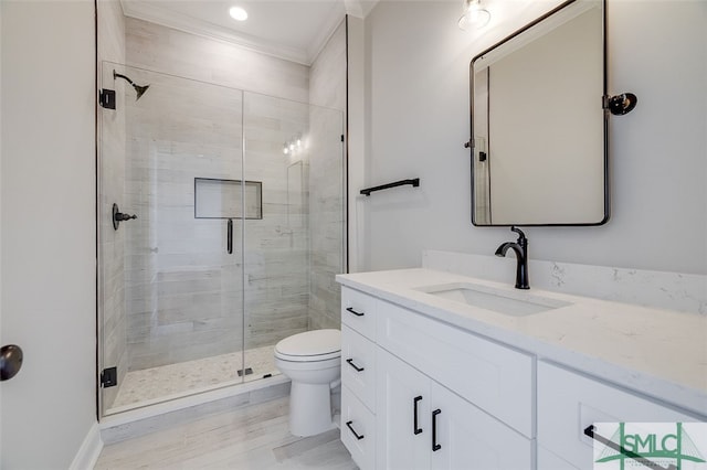 bathroom featuring crown molding, an enclosed shower, toilet, vanity, and hardwood / wood-style flooring