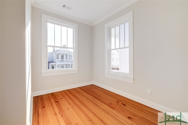 unfurnished room with hardwood / wood-style floors and ornamental molding