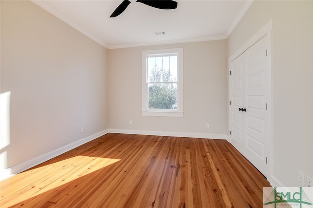 unfurnished room featuring crown molding, ceiling fan, and light wood-type flooring