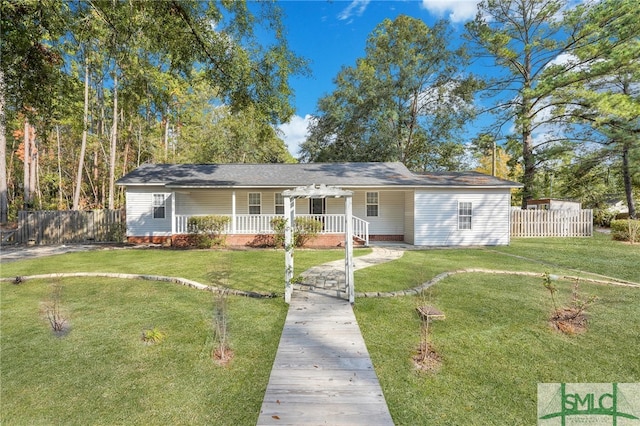 ranch-style home featuring a pergola and a front lawn