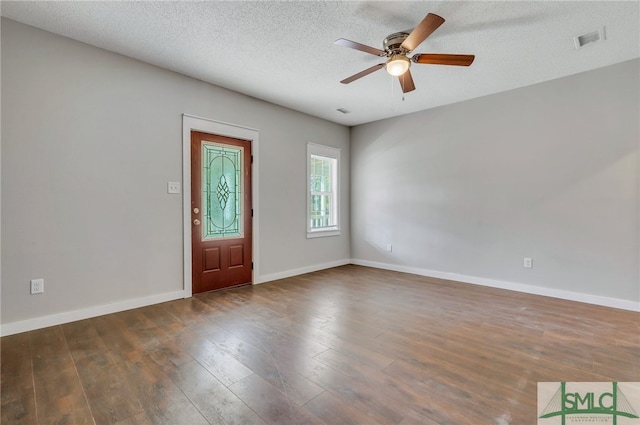 foyer with ceiling fan, dark hardwood / wood-style flooring, and a textured ceiling