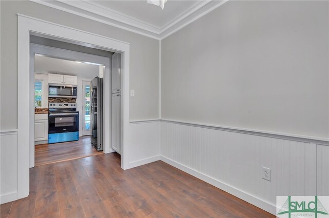 corridor with ornamental molding and dark wood-type flooring